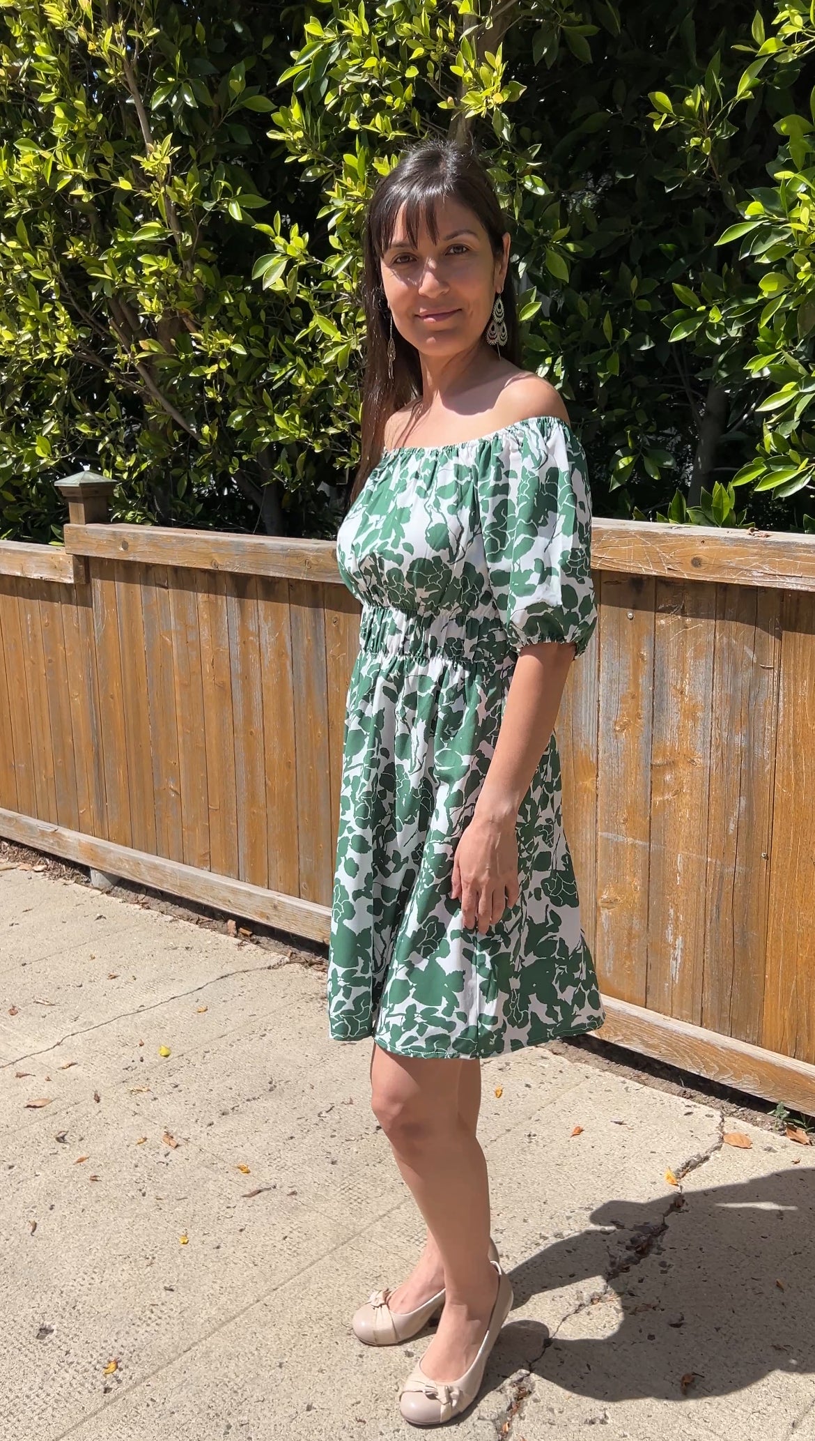 Woman in GreenOff-Shoulder Puff Sleeve Floral Mini Dress facing sideways