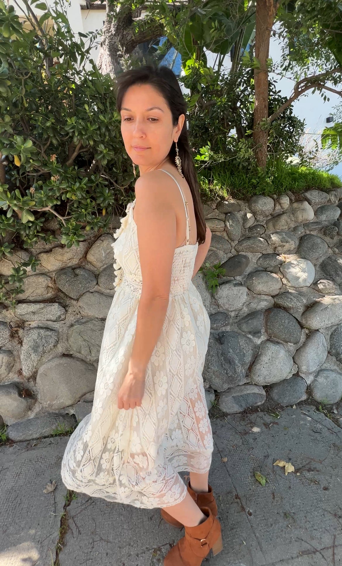 Woman in Beige Sleeveless Lace Cami Dress Boho Tassel facing sideways