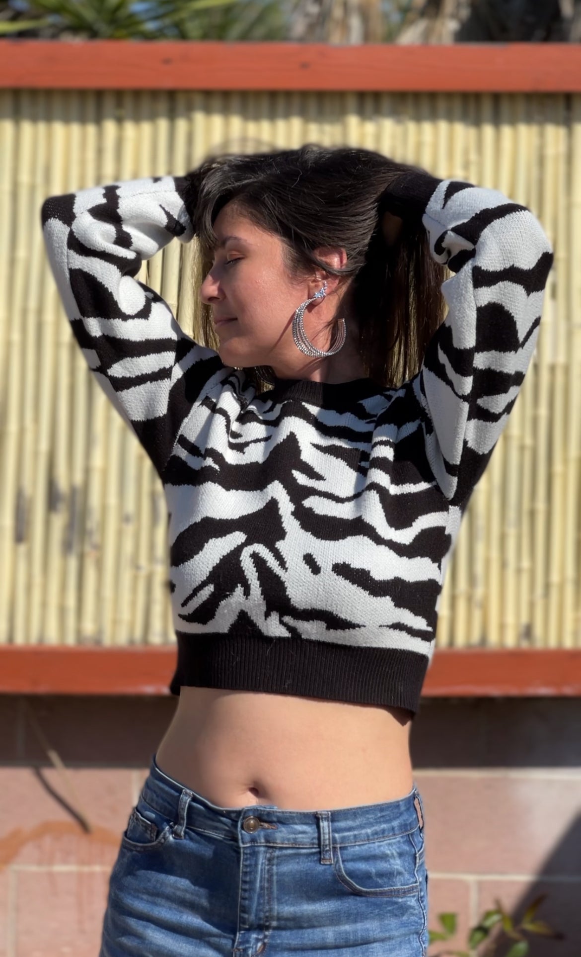 Woman in Black Zebra Print Crop Sweater facing forward up close