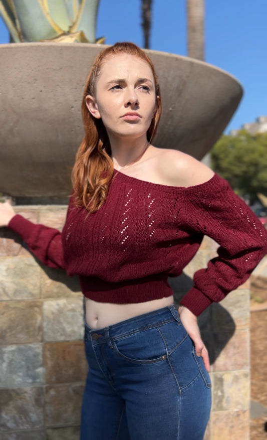 Woman in Burgundy One Shoulder Sweater facing Sideways up close