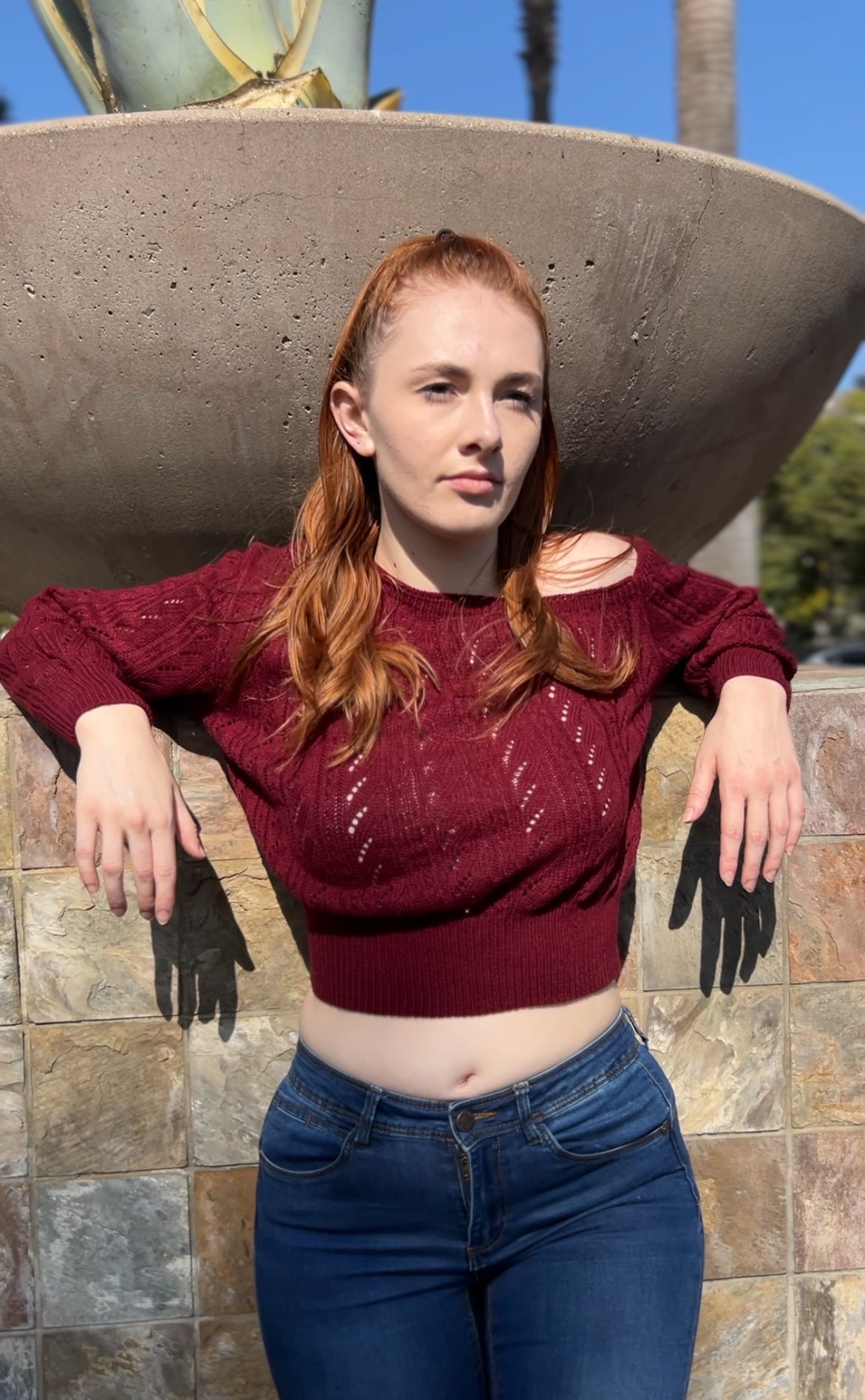 Woman in Burgundy One Shoulder Sweater facing forward up close