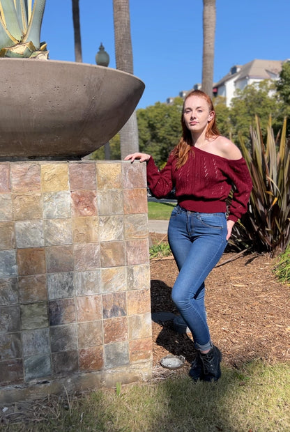 Woman in Burgundy One Shoulder Sweater facing forward