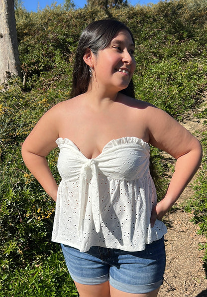 Woman in Chic White Eyelet Sweetheart Neckline Strapless Top with Tie Accent facing forward up Close