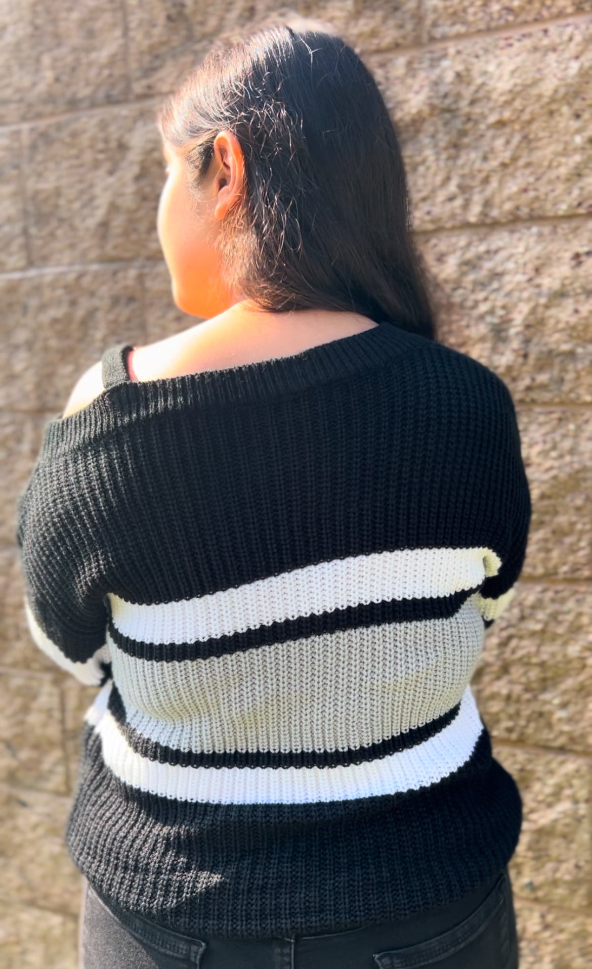 Woman in One-Shoulder Color Block Sweater  – Color Block Chain Strap Top facing backwards