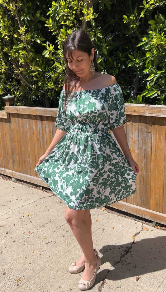 Woman in GreenOff-Shoulder Puff Sleeve Floral Mini Dress facing forward