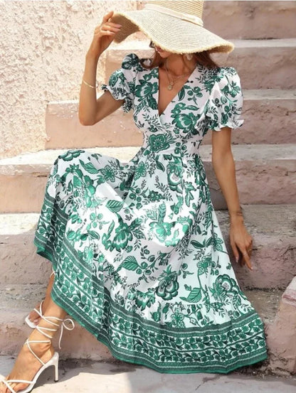Woman in Green & White Floral Midi Dress facing forward sitting down
