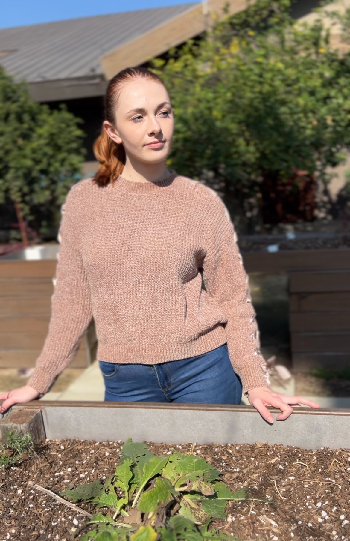 Woman in Khaki Lace Up Sleeve Knit Sweater facing forward up close