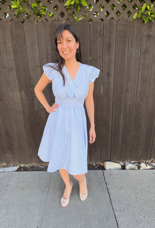 Woman in Light Blue Striped Mini Dress with Flutter Sleeves facing forward 