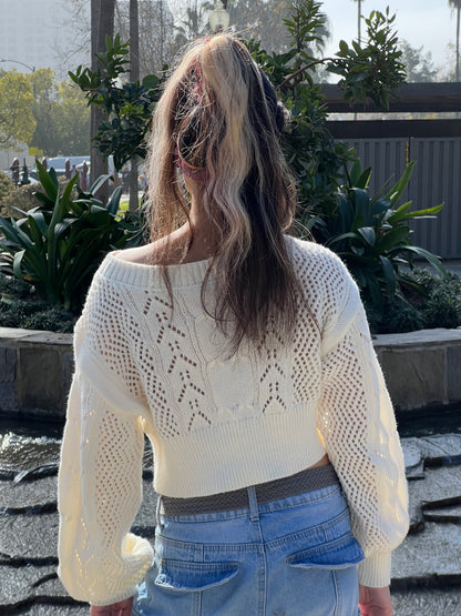 Woman in Neutral Beige Cropped Knit Top facing backwards up close 