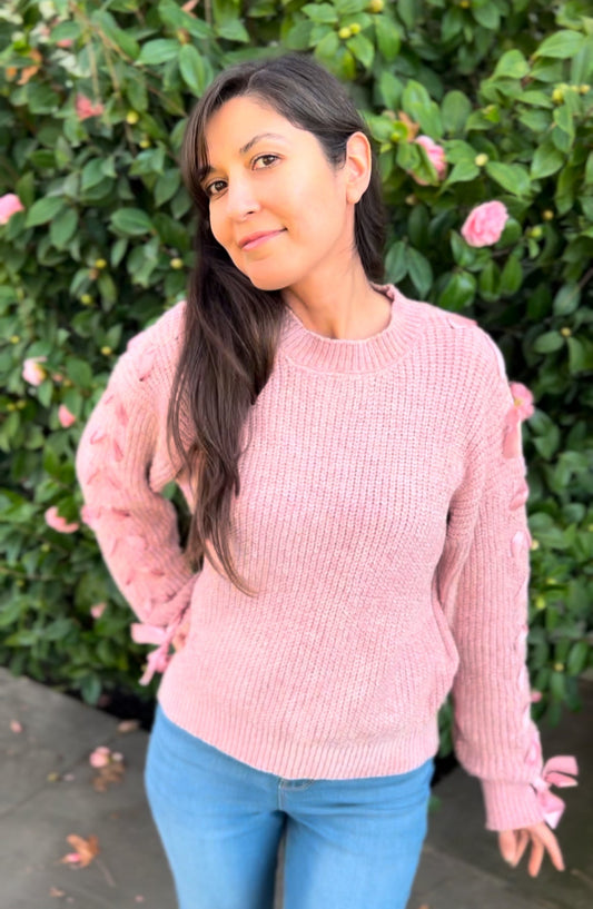 Woman in Lace Up Sleeves Knitted Sweater In Pink facing forward up close